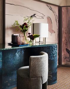 a bathroom with a vase of flowers on the wall at Park Lane New York in New York