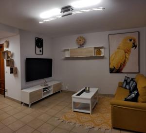 a living room with a couch and a television at Residencial Esquinzo 2 in Playa Jandia