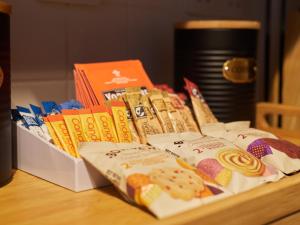a box of cookies and other snacks on a table at Cosy One Bed City Apartment -The Hub in Milton Keynes
