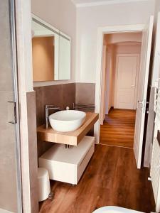 a bathroom with a sink and a mirror at The Square of Miracles Apartment in Pisa