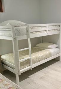 two white bunk beds in a room at Plaza Oz - Av Alemania in Temuco