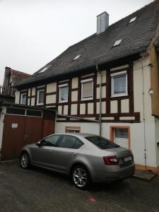 a car parked in front of a house at Gästehaus Ochsenhof in Feuchtwangen