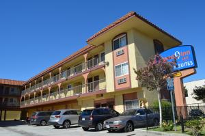a building with cars parked in a parking lot at Cloud 9 Inn LAX in Inglewood