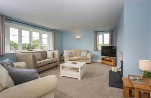 a living room with two couches and a tv at Overbrook in Droitwich