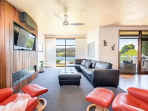 a living room with a couch and a tv at Little Oyster Bayview in Kettering