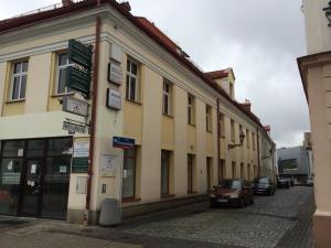 a building on a street with cars parked outside at Hostel Wiarus in Rzeszów