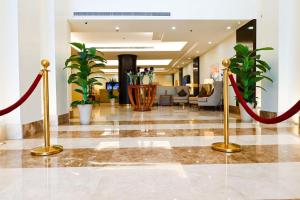 a lobby with red ribbon barriers in a hotel lobby at The Artisan Hotel-Suits in Jeddah