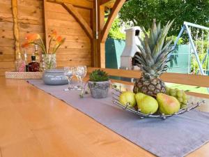 a table with a plate of fruit and wine glasses at Holiday home in Jadranovo 42254 in Jadranovo