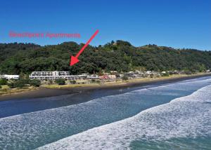 a red arrow points to the beachfront apartments at Beachpoint Apartments in Ohope Beach