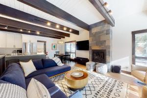 a living room with a blue couch and a fireplace at Maison de Montagne in Incline Village