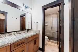 a bathroom with a sink and a toilet and a mirror at Maison de Montagne in Incline Village +23 photos