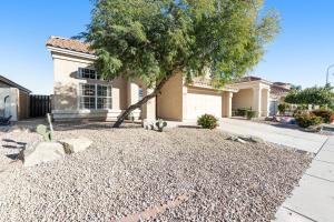 a house with a tree in front of it at Living Under Par in Phoenix