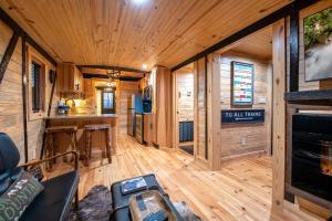 a large living room with wooden walls and wood flooring at Smoky Mountain Station in Pigeon Forge