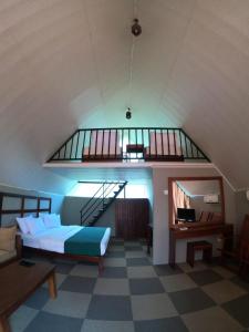 a bedroom with a bed and a staircase in a room at St.Clair Villas in Dimbula
