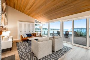 a living room with views of the ocean at Heron's Hideaway in Hansville