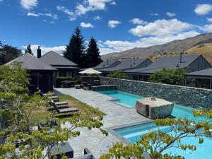 a backyard with a swimming pool and a house at Cardrona Mountain Villa in Cardrona