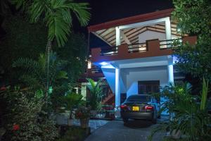 a car parked in front of a house at night at Green leaf Villa in Dambulla
