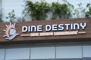 a sign on top of a dmg destiny fire dining restaurant at HOTEL OCEAN VISTA BAY in Visakhapatnam