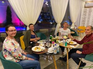 a group of people sitting at a table in a restaurant at Guest house TWINS in Tashkent