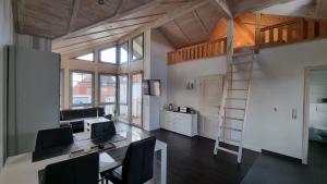 a living room with a loft bed and a desk at FeWo an der Ostsee Nr. 4 in Rerik