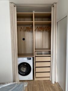 a closet with a washing machine and a washer at Superbe appartement Moderne Hyper centre de Vittel in Vittel