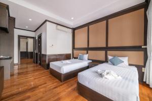 Postel nebo postele na pokoji v ubytování RimLay Beachfront Pool Villa