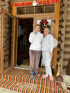 two women are standing in front of a mirror at Терношорська Лада in Snidavka