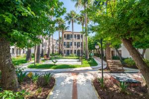 a walkway through a park with palm trees at Sundia By Liberty Oludeniz in Oludeniz
