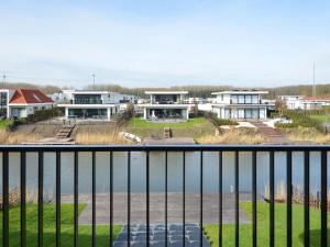 a view from a balcony of houses and a body of water at Luxury villa on the waterfront with jetty in Zeewolde