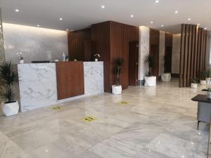 a lobby with potted plants in a building at فندق ايون الندى Ion Hotel in Riyadh