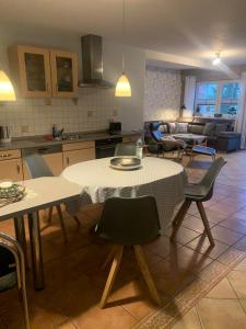 cocina y sala de estar con mesa y sillas en Ferienhaus Staben, en Eggstedt
