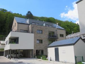a large brick building with a car parked in front of it at La Roche en Ardenne , welcome in La Roche-en-Ardenne