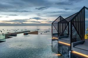 a hotel swimming pool with a view of the ocean at The Edge central pattaya in Pattaya