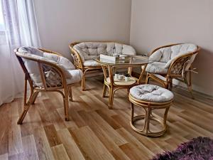 a room with chairs and a table and a couch at Jumiko Apartments in Vrnjačka Banja