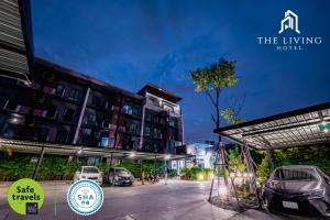 a parking lot in front of a building with cars parked at The Living Hotel SamutPrakan in Bang Bo