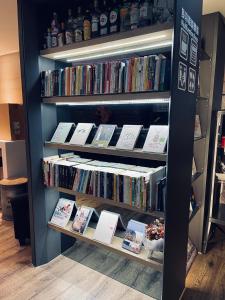 a book shelf filled with lots of books at Taiwan Youth Hostel & Capsule Hotel in Taipei
