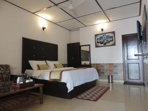 a bedroom with a large bed in a room at Ceyone Hotels in Mussoorie