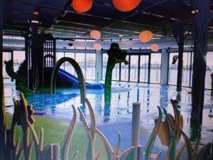 a swimming pool with a slide in a building at The Avenue in Tattershall