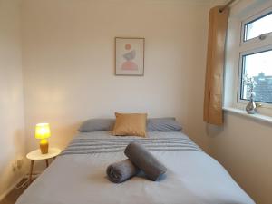 a bedroom with a bed with a stuffed animal on it at Stylish 3 Bedroom House with Free Parking in Norwich