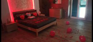 a bedroom with a bed with red balloons on the floor at Suite Natura Bed&Beauty Spa in Taranto