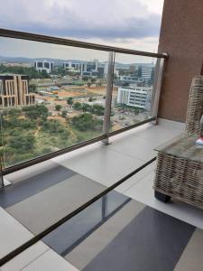 a balcony with a view of a city at Abeach Apartment on 3rd in Gaborone