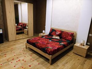 a bedroom with a bed with red sheets and a mirror at Suite Natura Bed&Beauty Spa in Taranto +41 photos