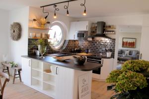 a kitchen with white cabinets and a black counter top at Fine Home in Timmendorfer Strand