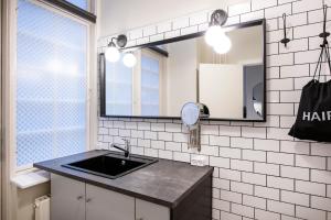 a bathroom with a sink and a mirror at The Citadel Apartments by Daniel&Jacob's in Copenhagen +56 photos