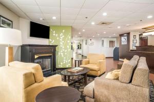 a waiting room with couches and a fireplace at Sleep Inn & Suites Jacksonville near Camp Lejeune in Jacksonville