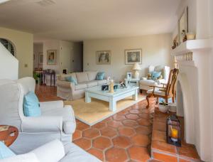 a living room with couches and a table at Kate Stanton Inn in Encinitas