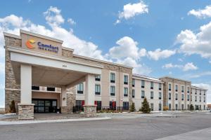 a building with a sign on the front of it at Comfort Inn & Suites Sidney I-80 in Sidney