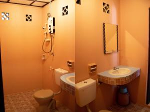 a bathroom with a toilet and a sink at BUSHMAN TIOMAN in Tioman Island