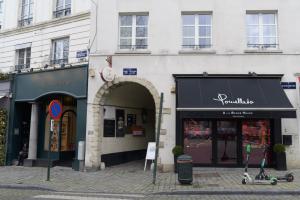 a group of shops on a city street at Private en-suite room in the heart of Le Sablon in Brussels