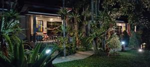 a house with a garden at night at Fill - Feel @ Long Beach Resort in Ko Lanta